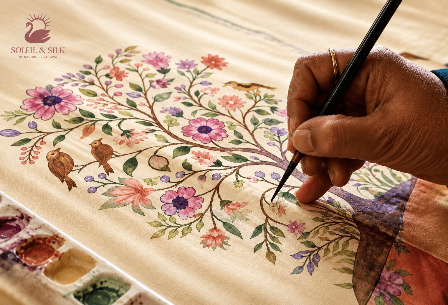 Artist hand painting a handcrafted saree
